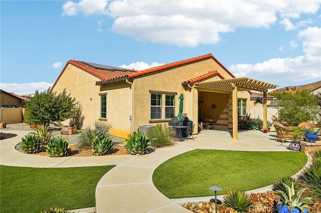 back of property featuring a yard, a patio, and a pergola