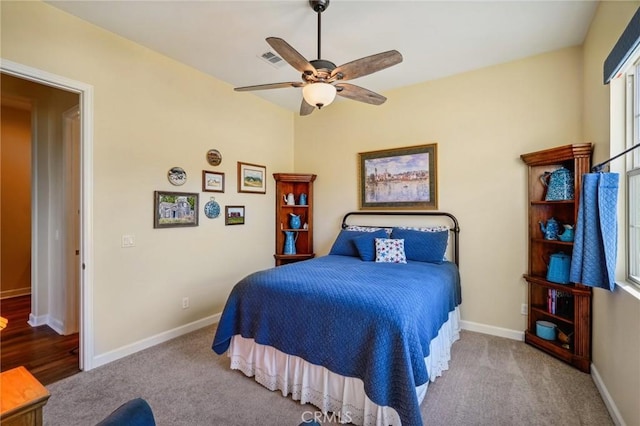 bedroom featuring light carpet and ceiling fan