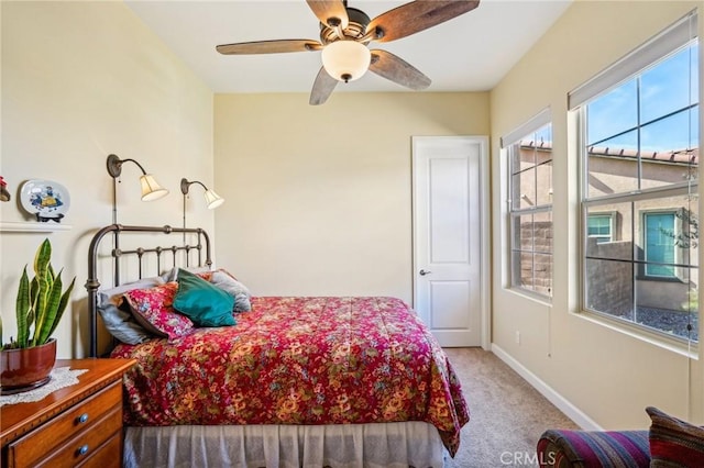 bedroom with light carpet and ceiling fan