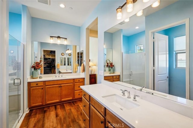 bathroom featuring vanity, wood-type flooring, and an enclosed shower