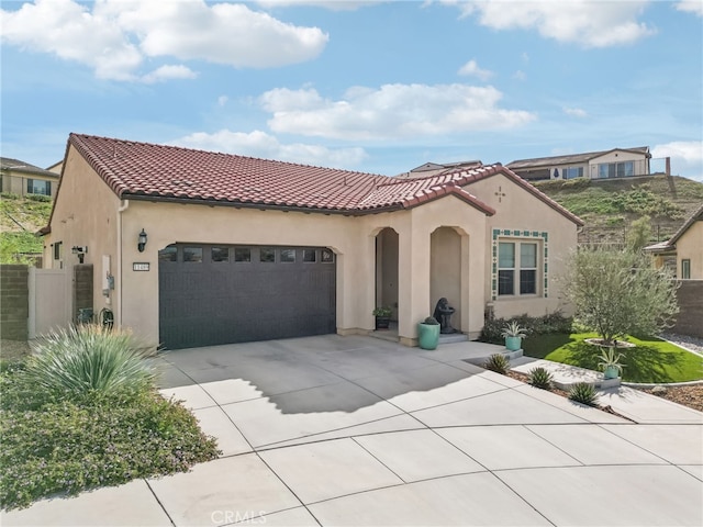 mediterranean / spanish-style home featuring a garage