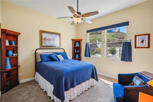 bedroom featuring ceiling fan and carpet