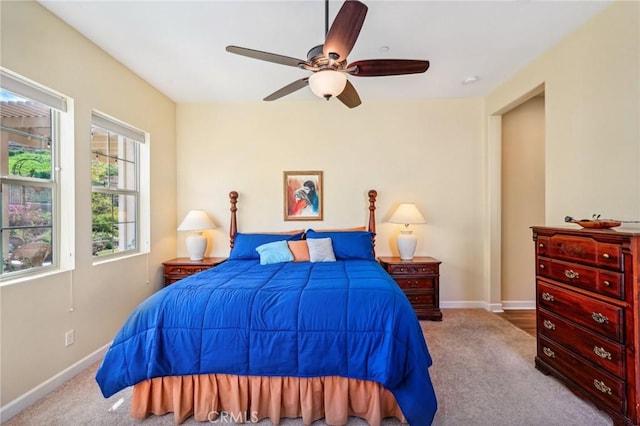 bedroom with ceiling fan and light colored carpet