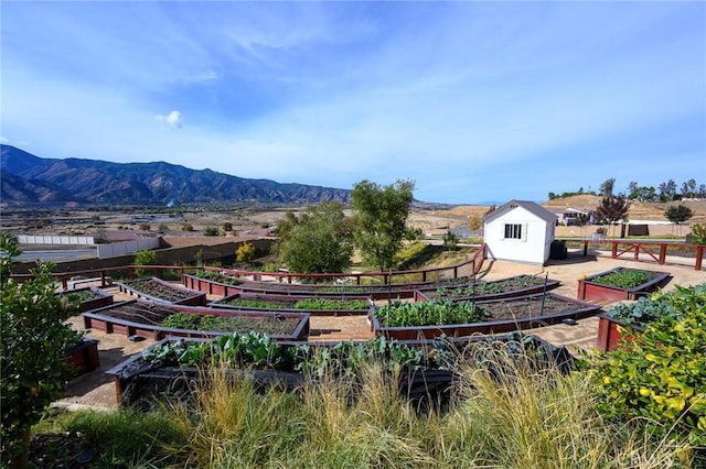 view of home's community featuring a mountain view and a storage shed