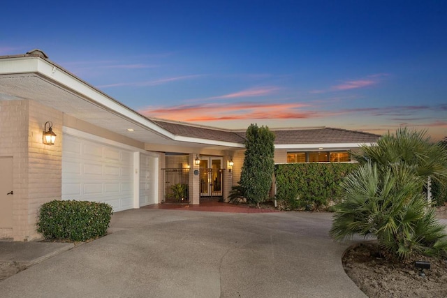 exterior entry at dusk with a garage