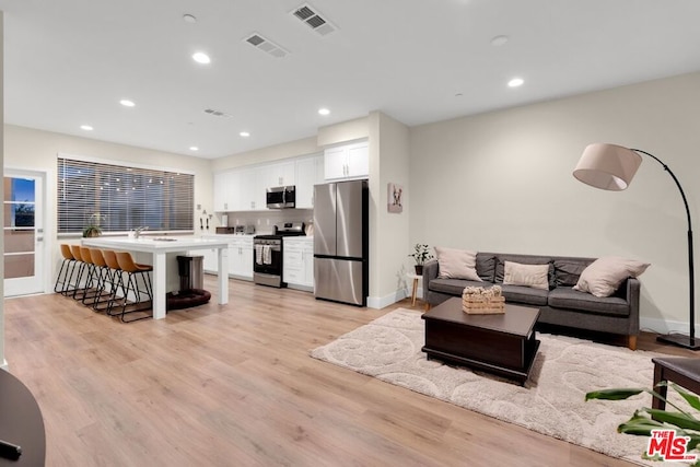 living room with light hardwood / wood-style flooring