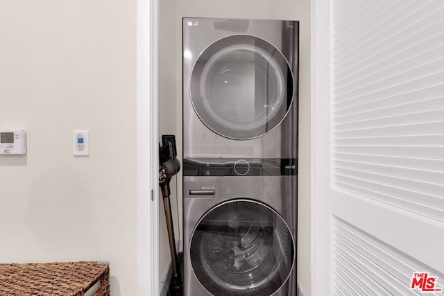 laundry room with stacked washer / drying machine