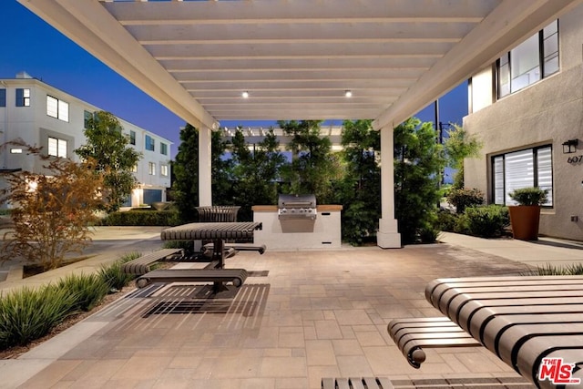 view of patio / terrace featuring a pergola, area for grilling, and a grill