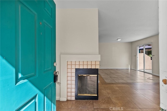 tiled foyer entrance featuring a tiled fireplace