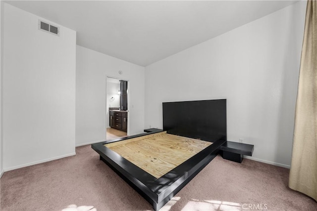 carpeted bedroom featuring ensuite bathroom