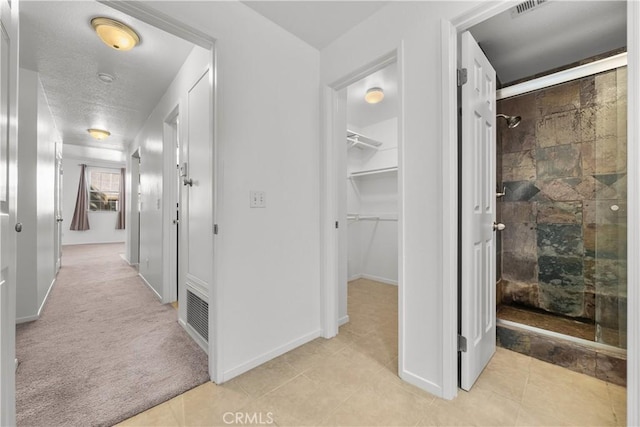 hallway with light colored carpet