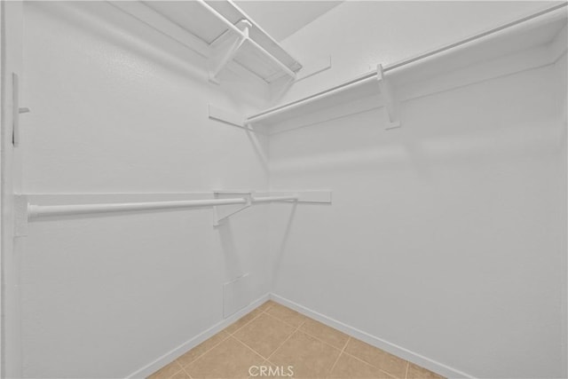 walk in closet featuring tile patterned flooring