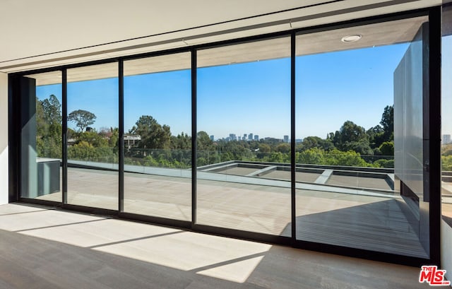 doorway featuring hardwood / wood-style flooring and a wall of windows