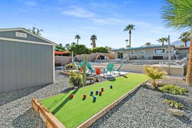 view of yard featuring a fenced in pool, a patio area, and pool water feature