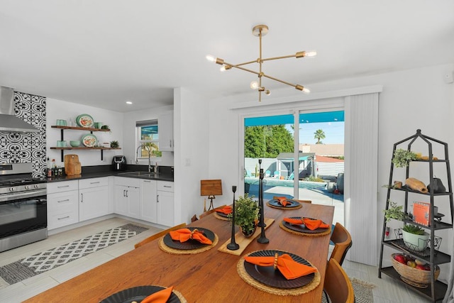 dining space featuring an inviting chandelier and sink