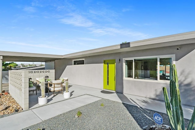 doorway to property with a patio area