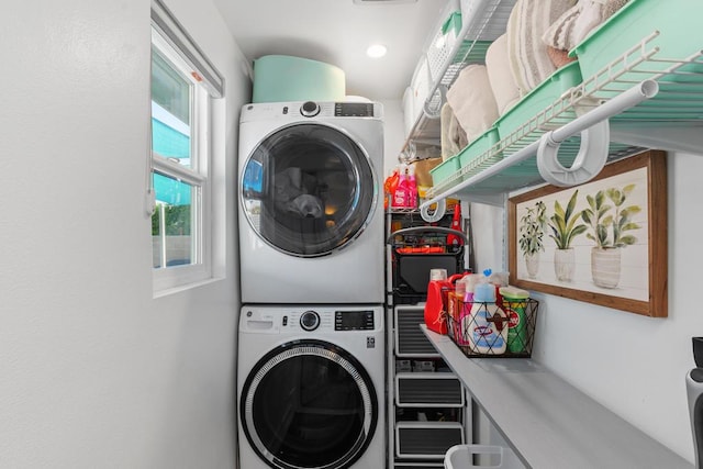 laundry area with stacked washer and clothes dryer