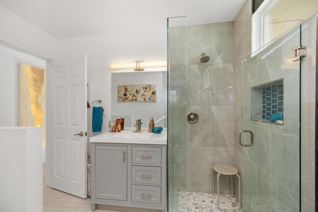 bathroom with walk in shower and vanity