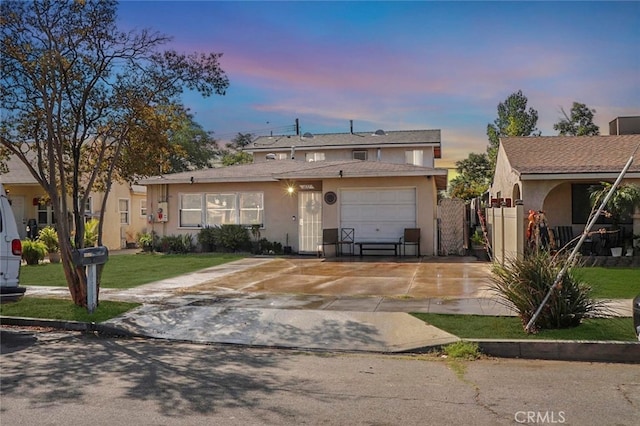 1037 Virginia Ave, Colton, CA 92324 - view of front of home with concrete driveway, stucco siding, a garage, and a front lawn
