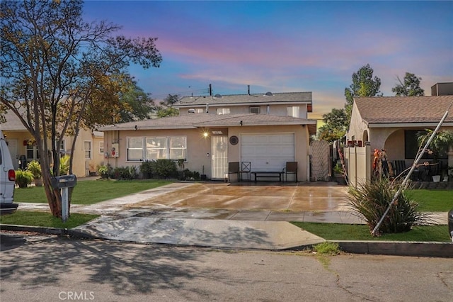 1037 Virginia Ave, Colton, CA 92324 - view of front of house featuring stucco siding, concrete driveway, a garage, and a front lawn