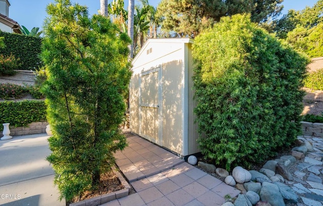 view of storm shelter with a storage unit