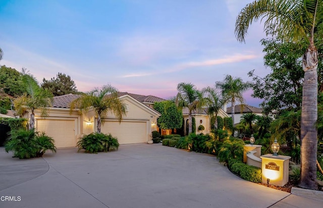 mediterranean / spanish-style home with a garage