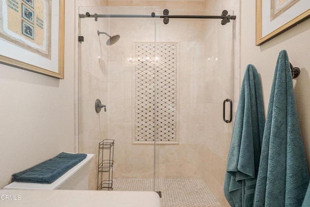 bathroom featuring a shower with door