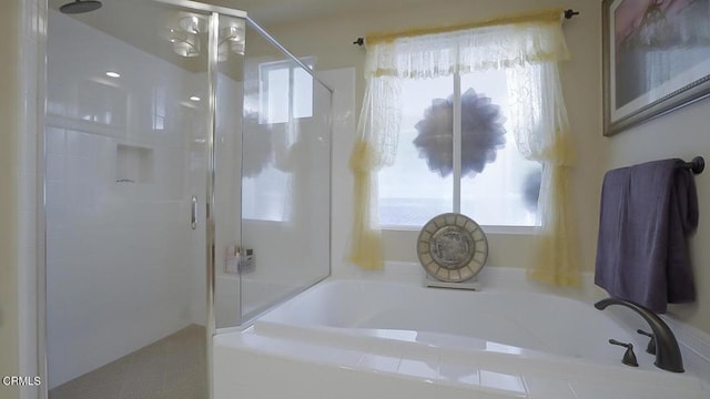 bathroom with shower with separate bathtub