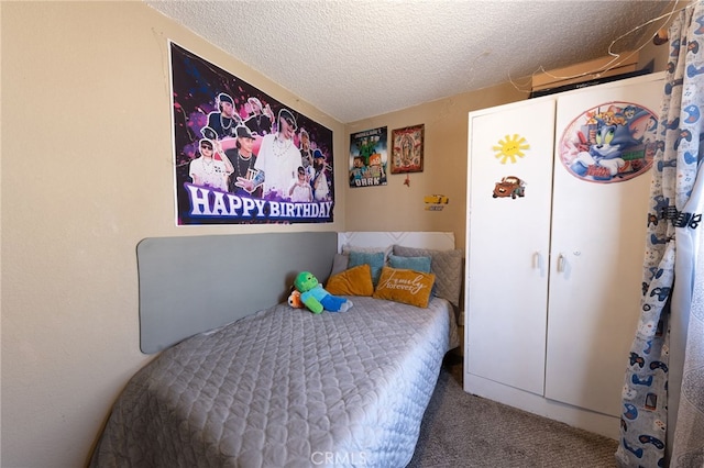 carpeted bedroom featuring a textured ceiling