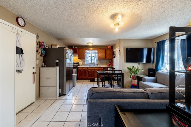 tiled living room with a textured ceiling and sink