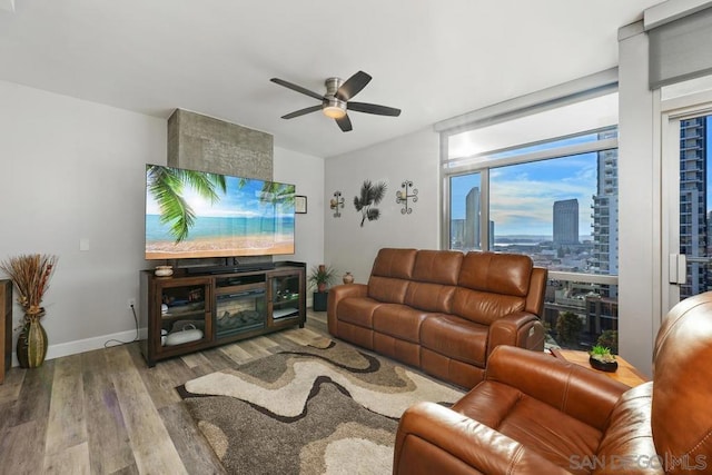 living room with ceiling fan and light wood-type flooring