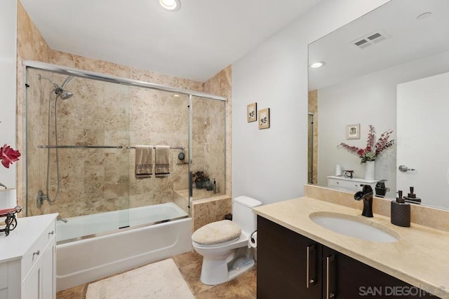 full bathroom with toilet, bath / shower combo with glass door, and vanity