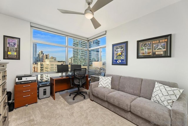 office area with ceiling fan, light carpet, and floor to ceiling windows