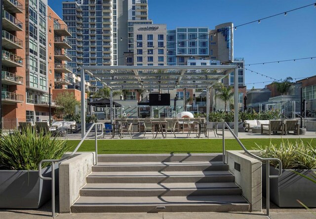 view of property's community with outdoor lounge area and a pergola