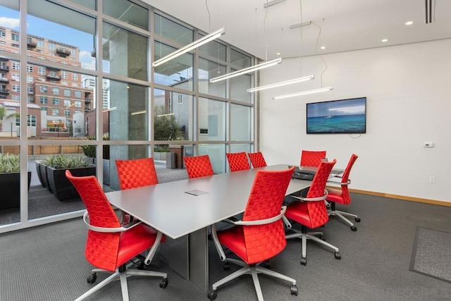 office with carpet floors, a wall of windows, and plenty of natural light