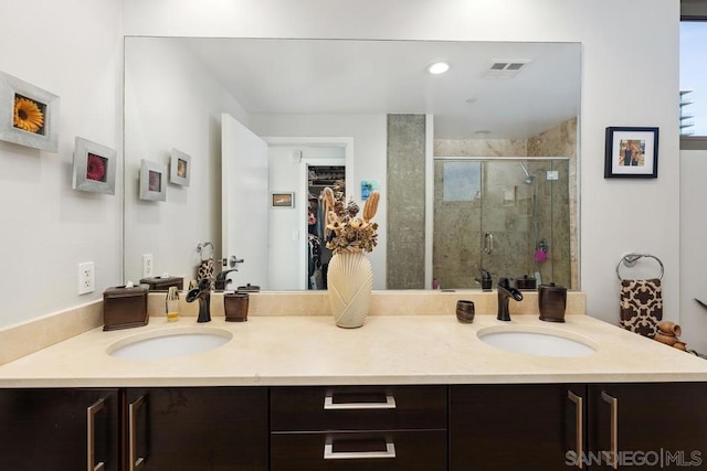 bathroom with an enclosed shower and vanity