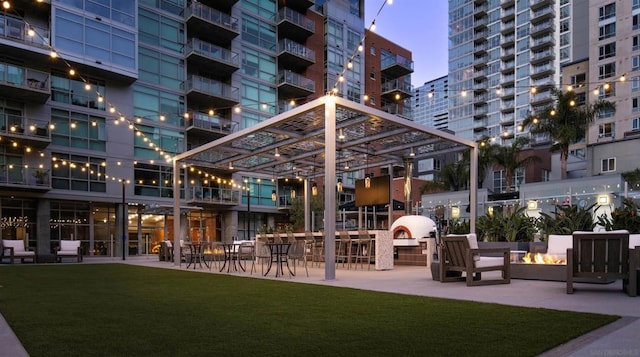 view of property's community featuring a pergola and a lawn