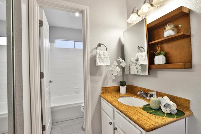 full bathroom featuring vanity, toilet, and tiled shower / bath combo