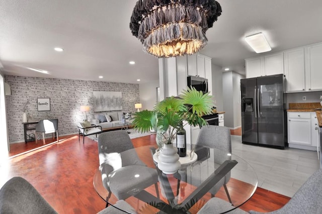 dining space featuring an inviting chandelier and light hardwood / wood-style floors