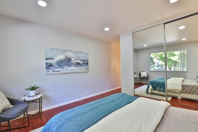 bedroom featuring dark hardwood / wood-style flooring and a closet