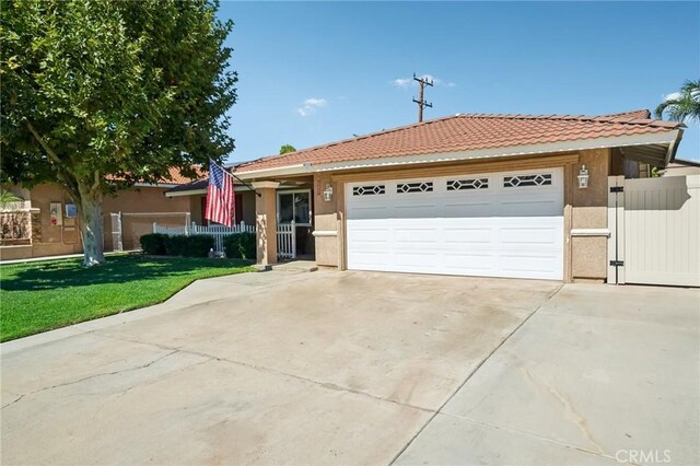 ranch-style home featuring a garage and a front lawn