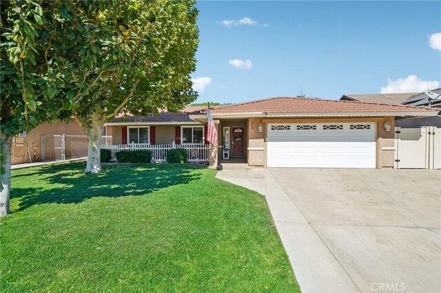 ranch-style house with a garage, a front lawn, and covered porch