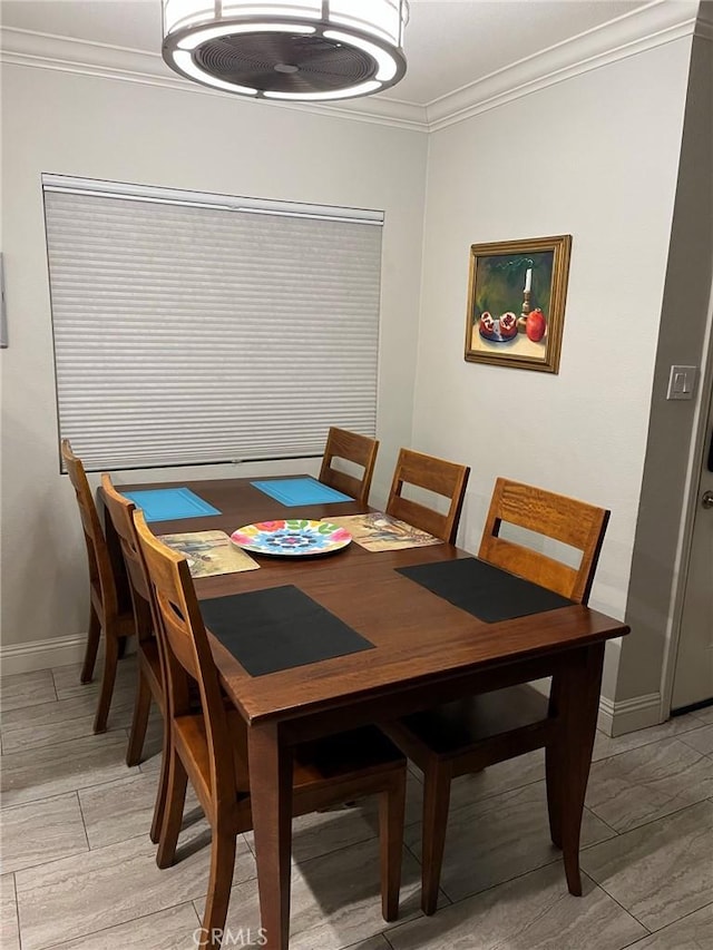 dining area featuring ornamental molding and light hardwood / wood-style floors