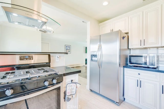 kitchen featuring appliances with stainless steel finishes, island range hood, and white cabinets