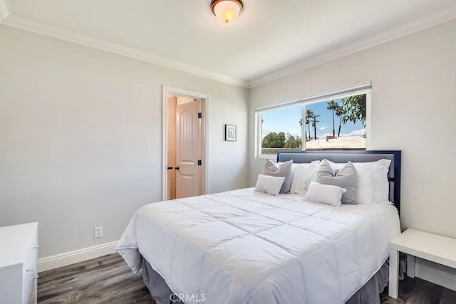 bedroom with crown molding and dark wood-type flooring