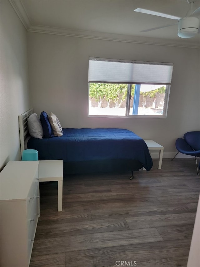 bedroom featuring ornamental molding, dark wood-type flooring, and ceiling fan