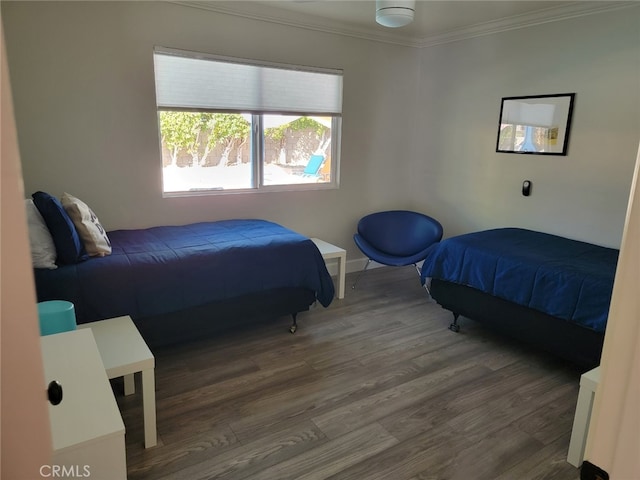 bedroom with crown molding and wood-type flooring