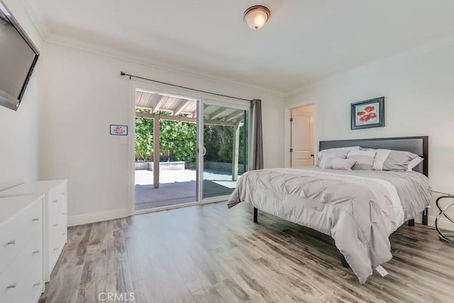 bedroom with access to exterior, crown molding, and light wood-type flooring