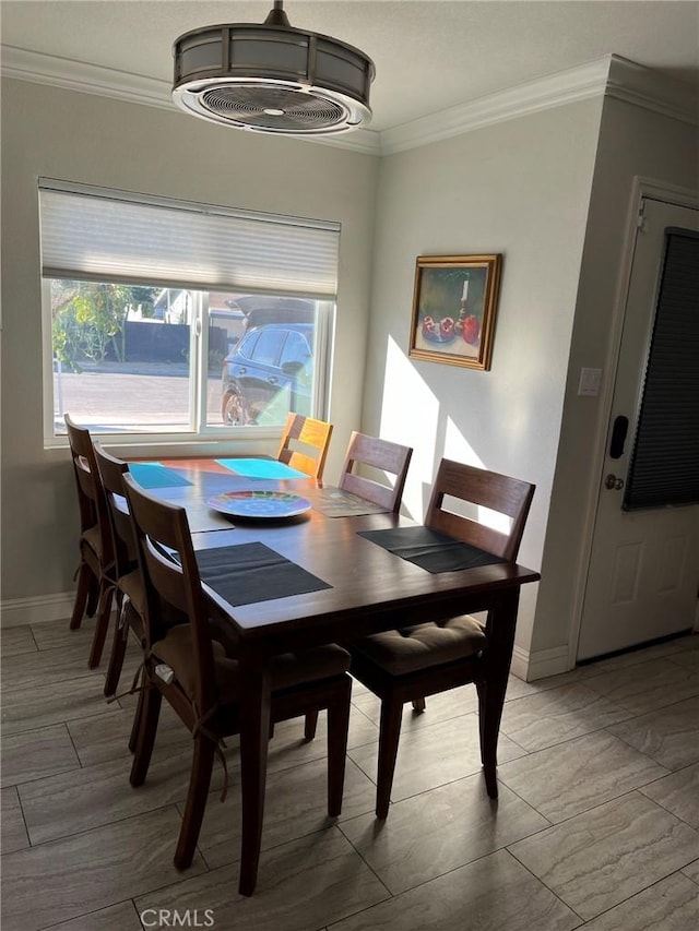 dining area featuring crown molding, plenty of natural light, and light hardwood / wood-style floors