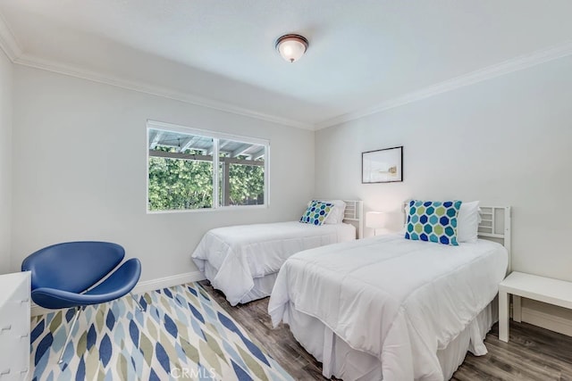 bedroom featuring dark wood-type flooring and crown molding